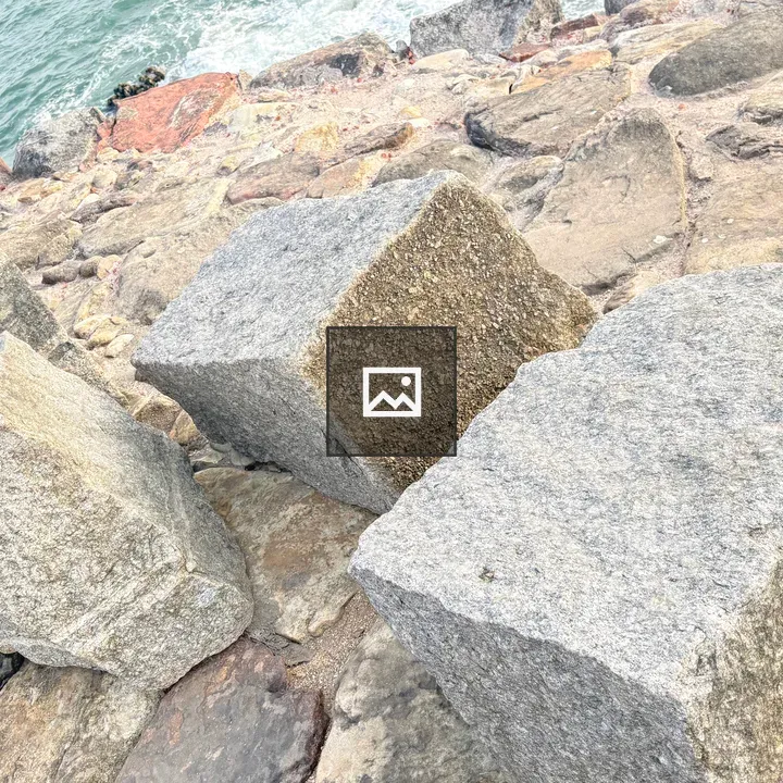 Three stone blocks on shoreline