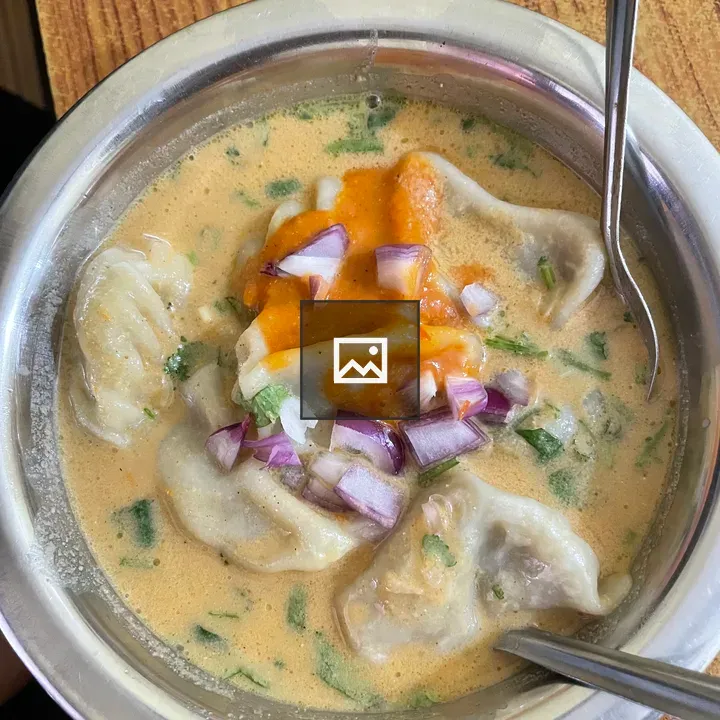 Top-down Nepalese jhol momo in broth