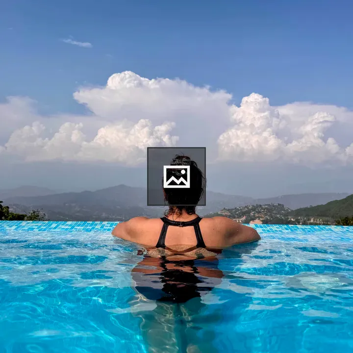 Person in Infinity Pool with Mountain View