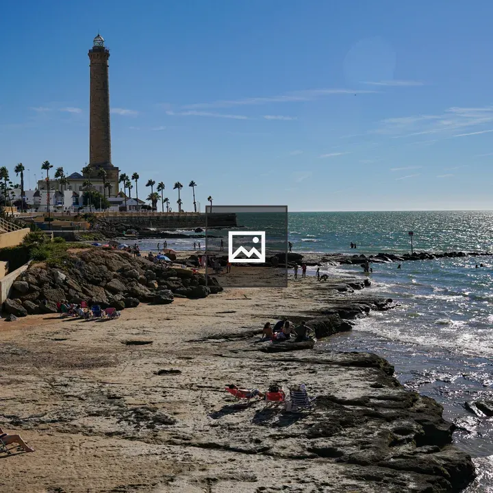 Lighthouse and Beach Scene in Chipiona