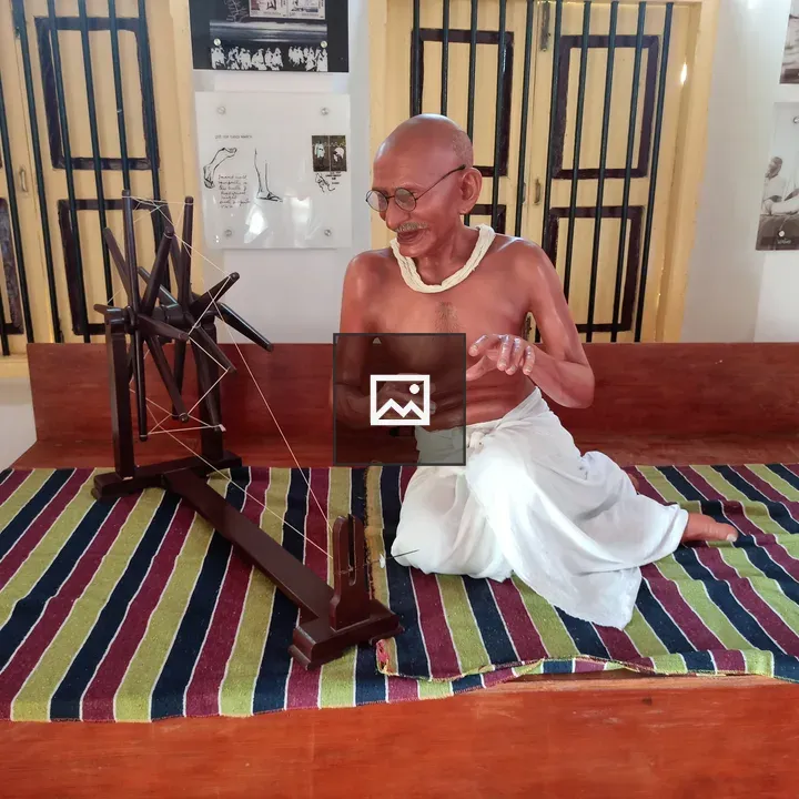 Statue of Gandhi weaving charkha