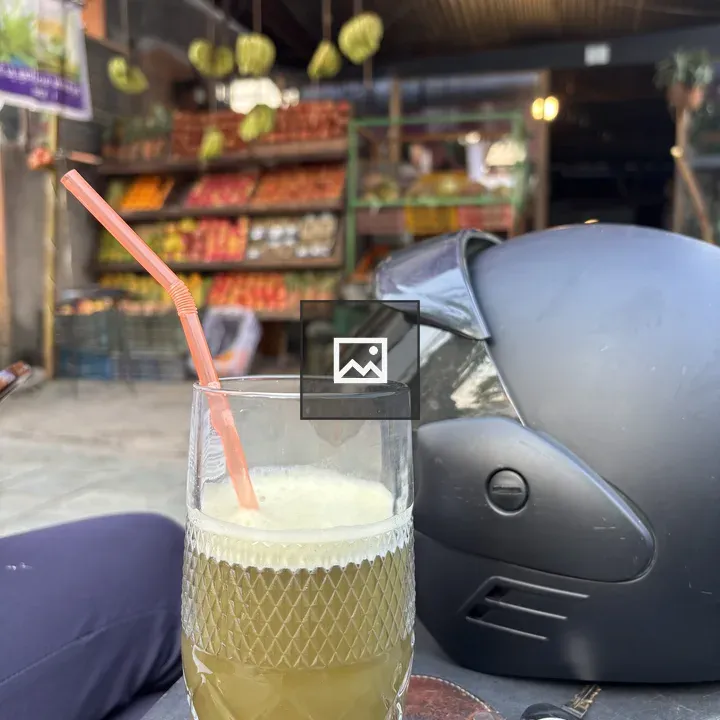 Glass of green juice with accessories