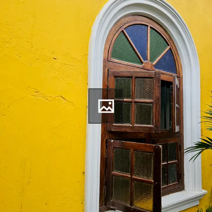 Wooden arched window with stained glass