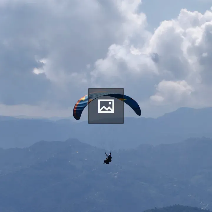 Paragliding Above Mountain Landscape