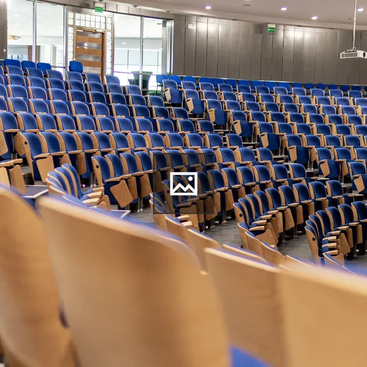 Empty University Auditorium with Blue Chairs