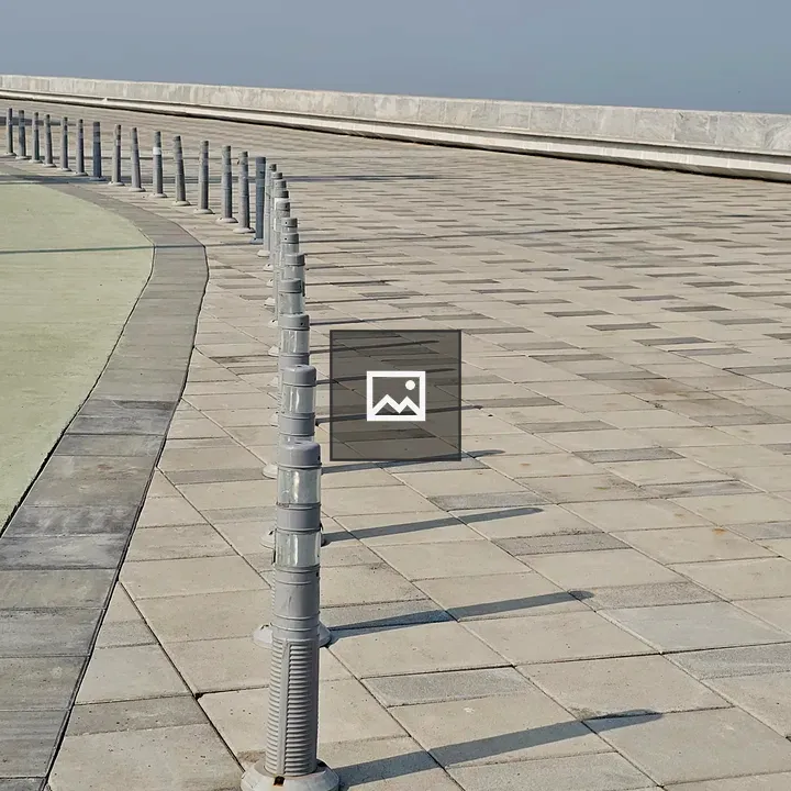 Row of grey bollards along walkway