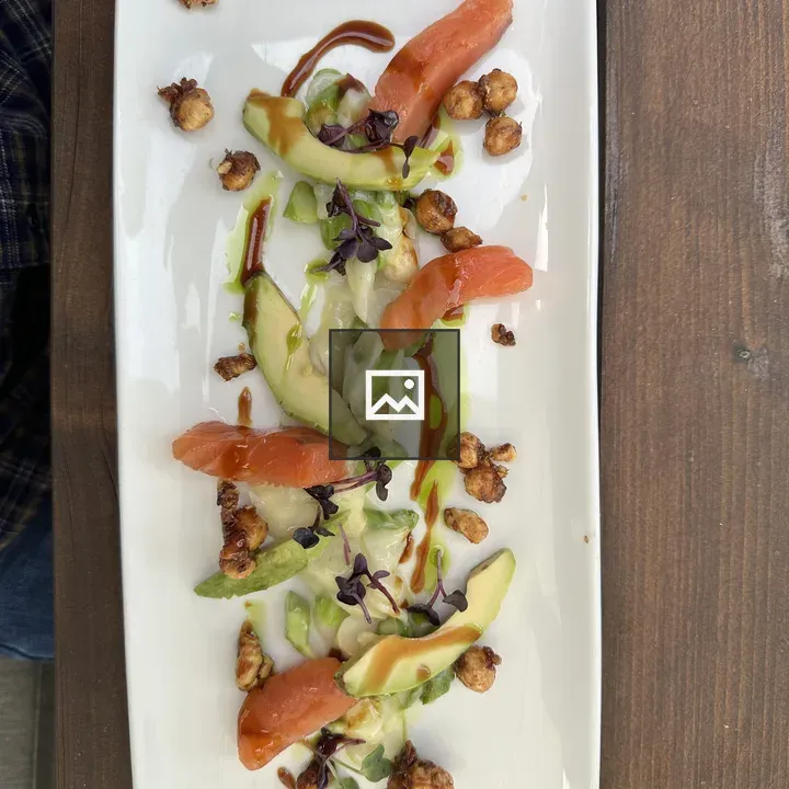 Smoked salmon plate with avocado and nuts