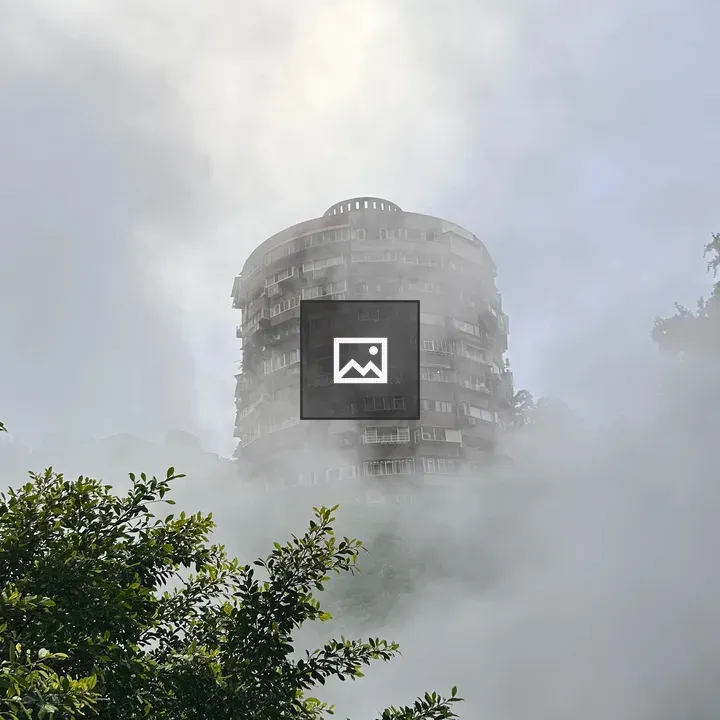 Tall cylindrical building in mist