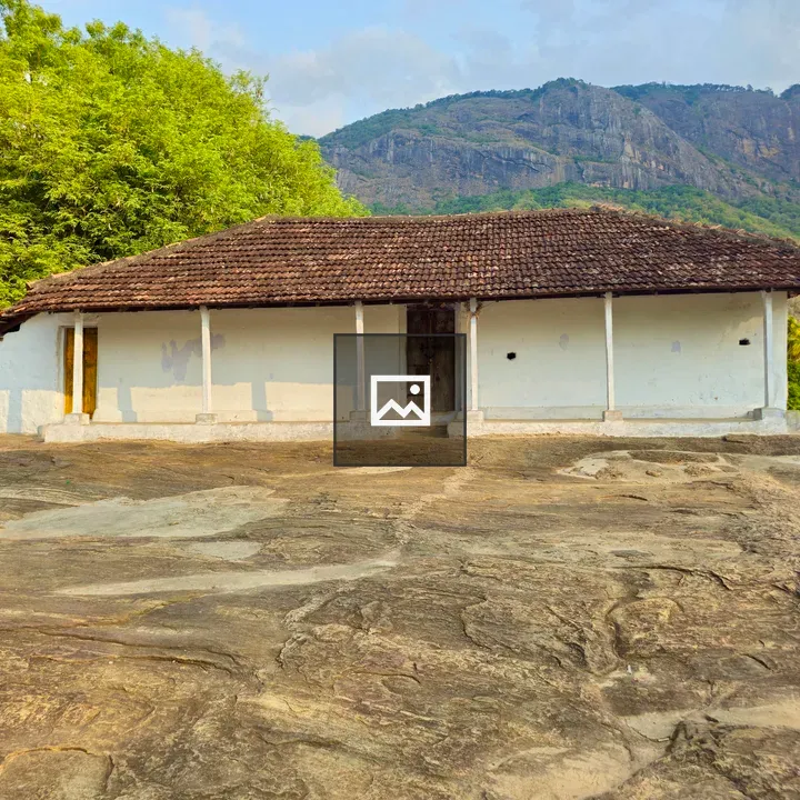 Kerala-Style House Amid Rocky Landscape