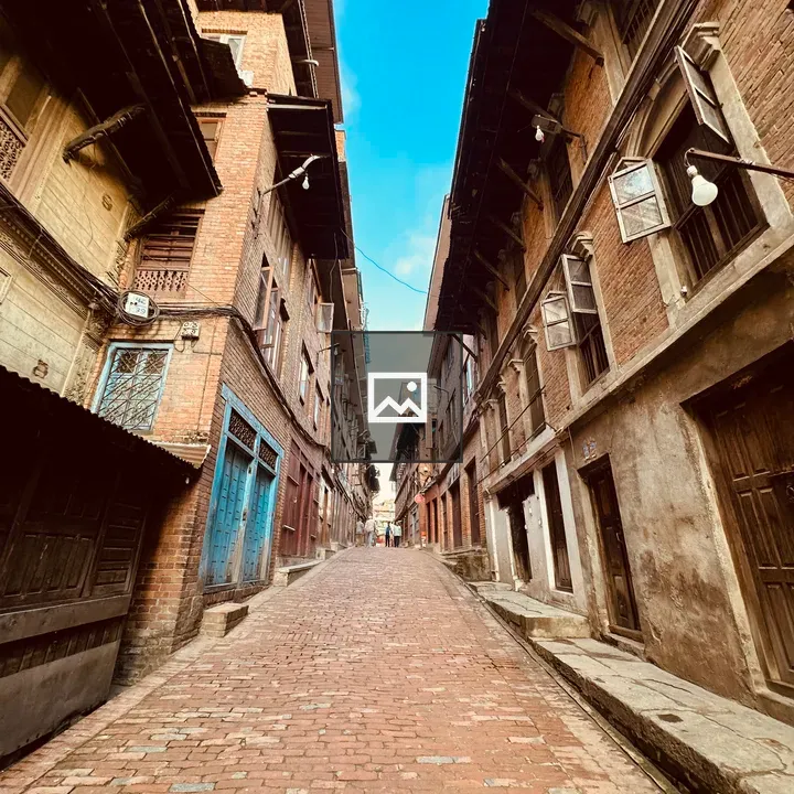 Narrow cobblestone street with traditional buildings