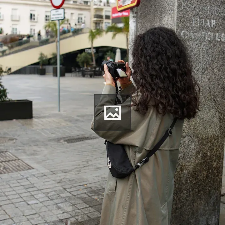 Woman with DSLR on City Street