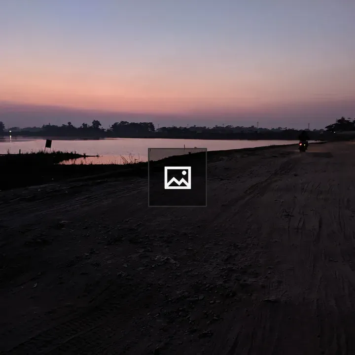 Dirt road at sunset with river