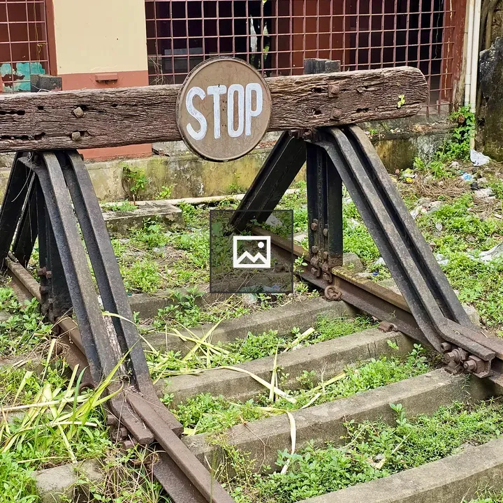 Rusted railway buffer stop with STOP sign