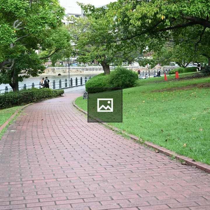 Winding brick path through a green park