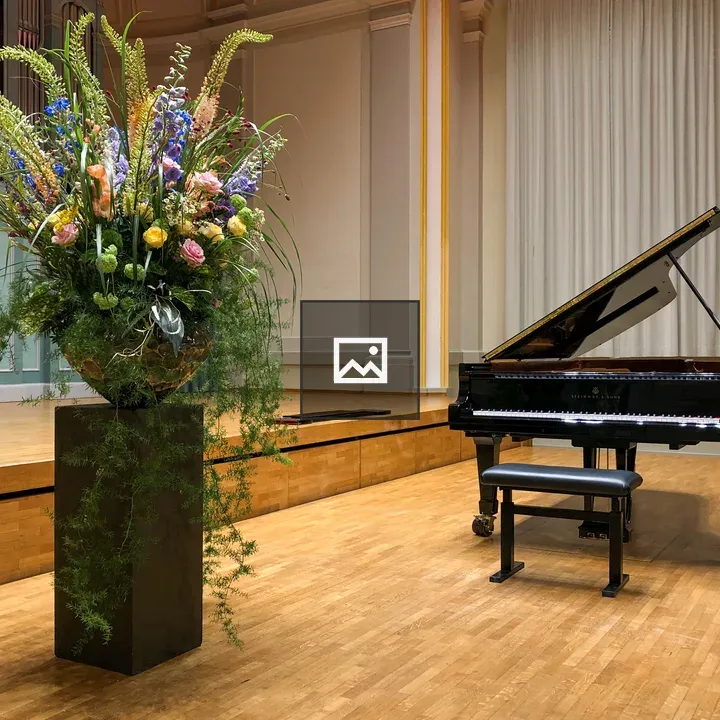 Grand piano in hall with flowers