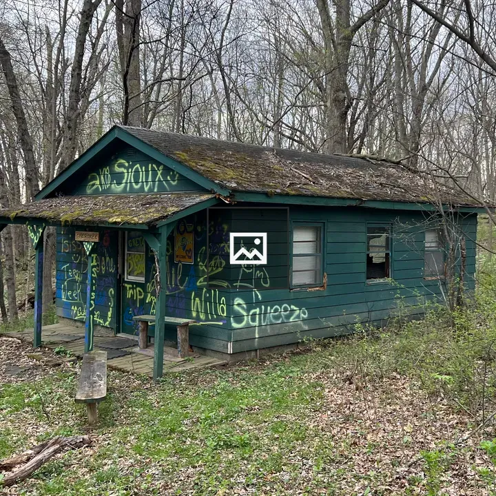 Abandoned green wooden cabin
