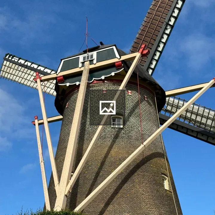 Windmill closeup against blue sky