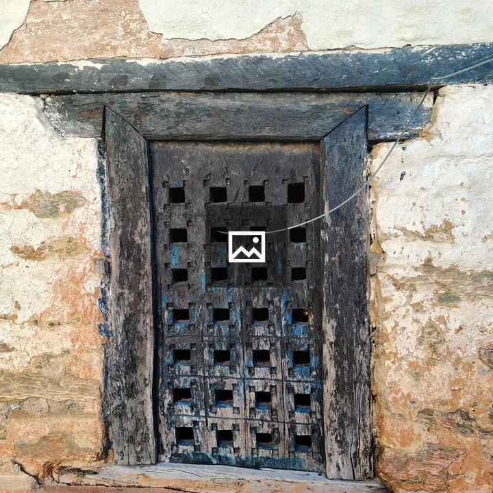 Old wooden window with square cutouts