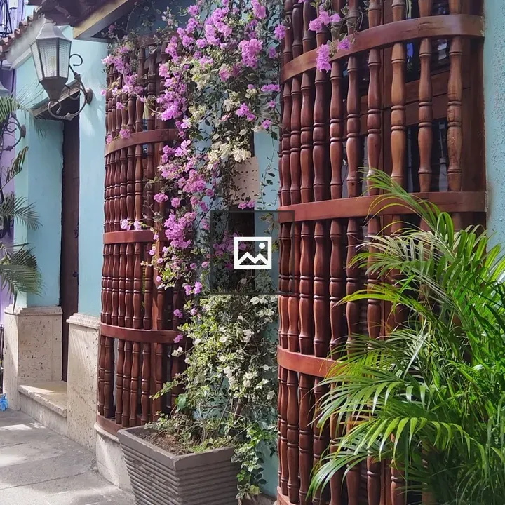 Turquoise Colonial Building with Flowers