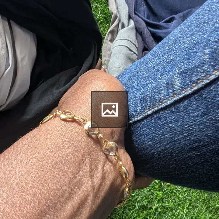 Hand with gold heart bracelet