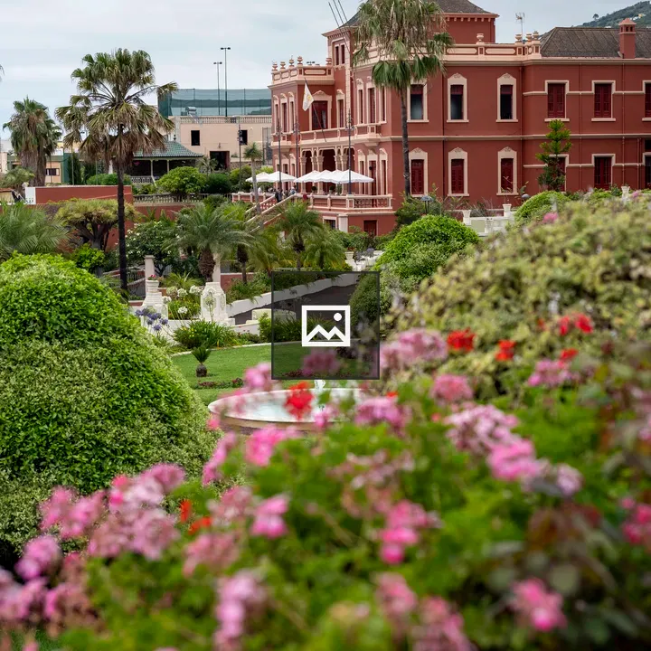 Grand red building with gardens
