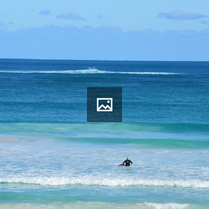 Surfer with Surfboard at Beach