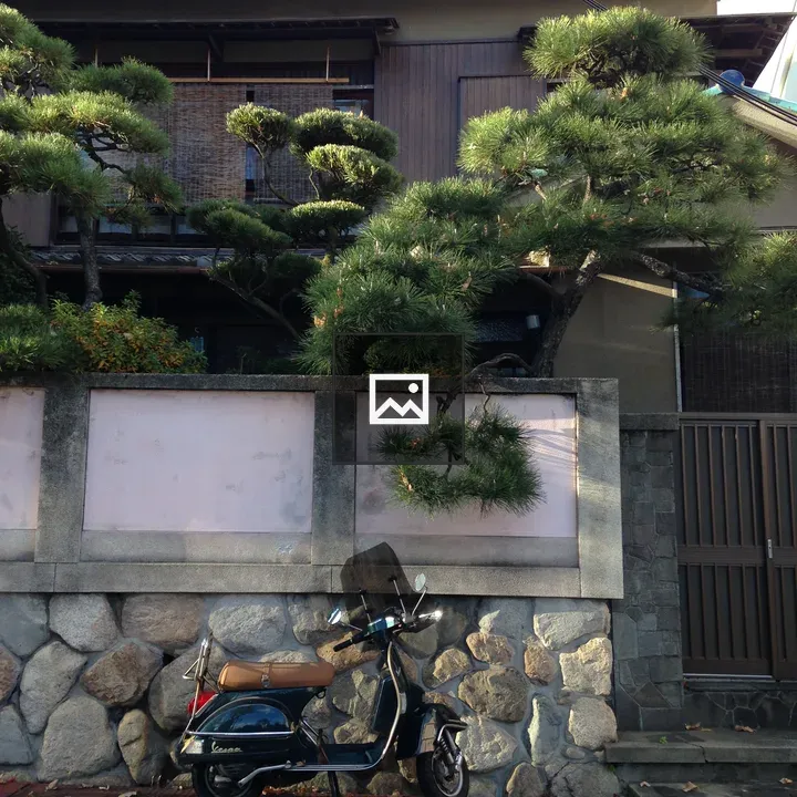 Vespa in front of Japanese house