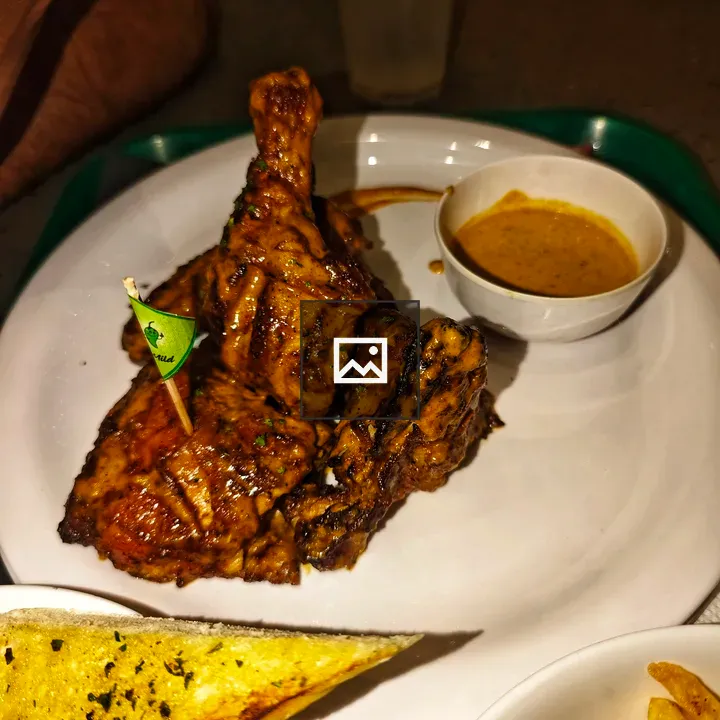 Plate of grilled chicken leg