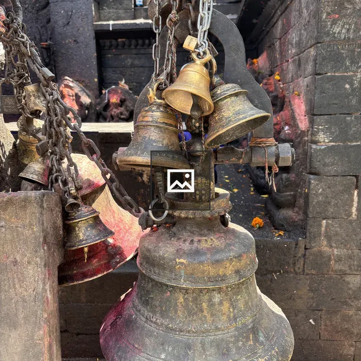 Rustic bells on stone wall