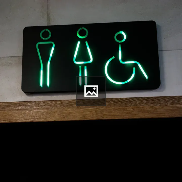 Green neon restrooms sign