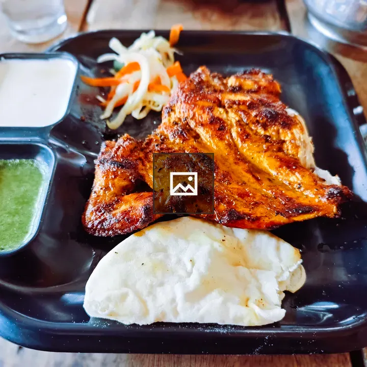 Grilled chicken on black plate