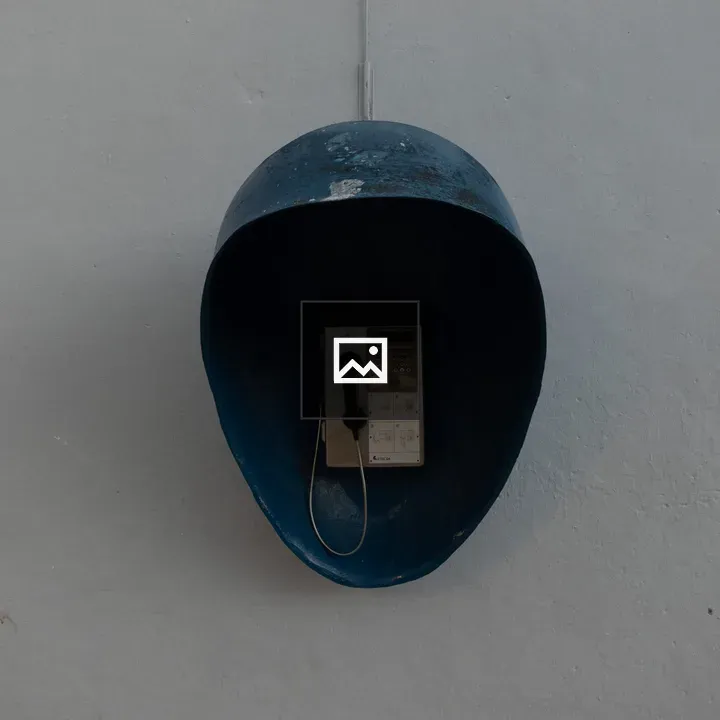 Vintage payphone with blue helmet cover