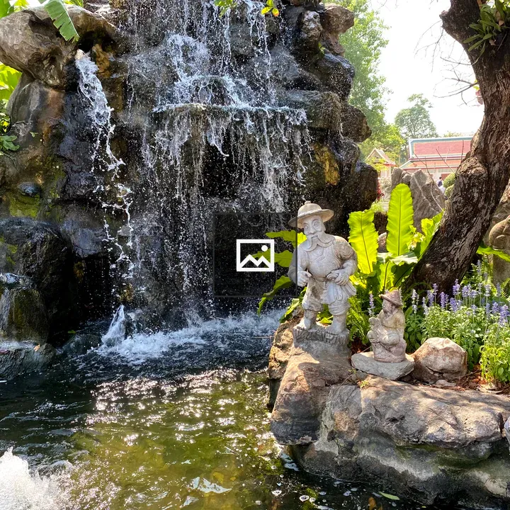 Waterfall with stone statues