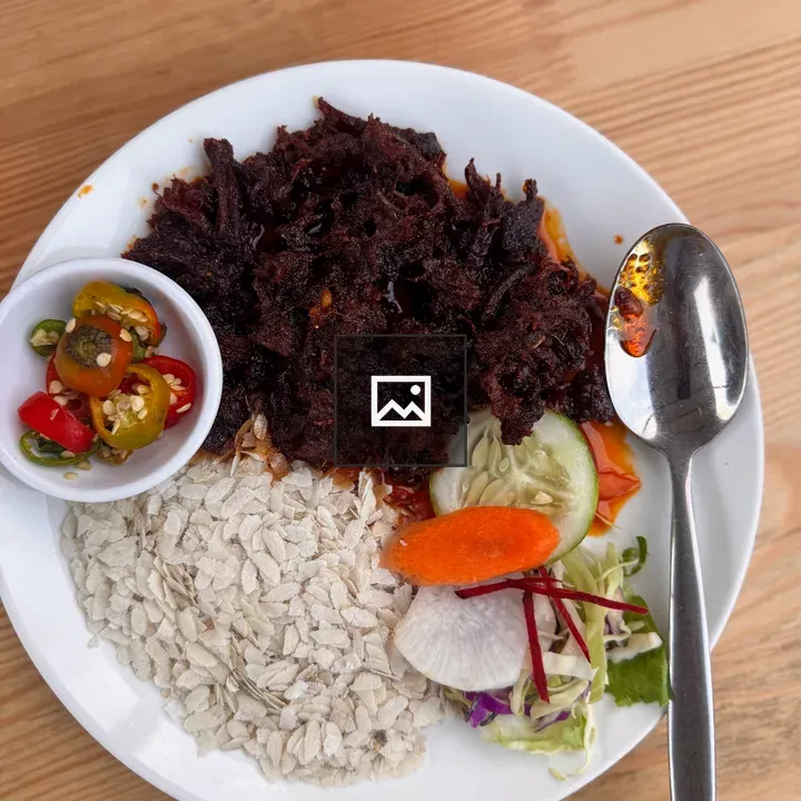 Shredded beef on plate with chiura and salad