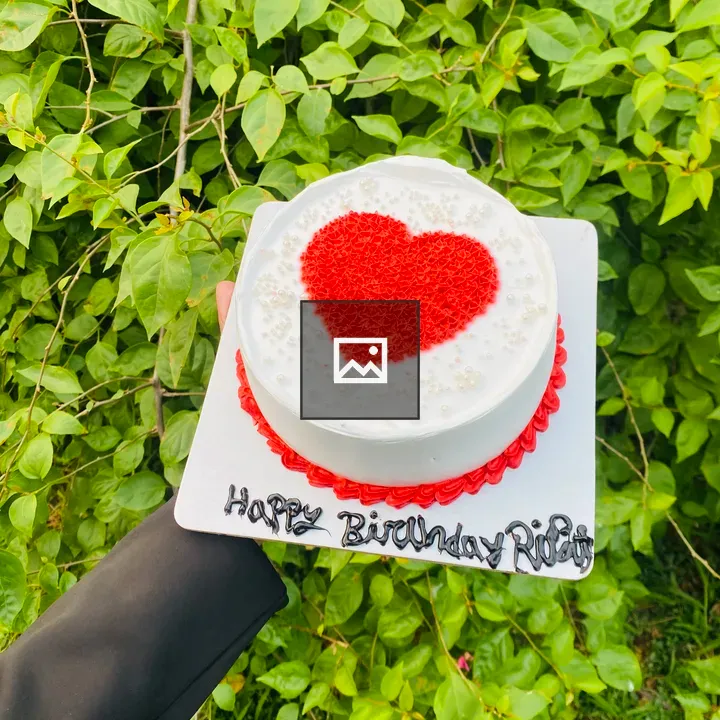 Hand holding birthday cake