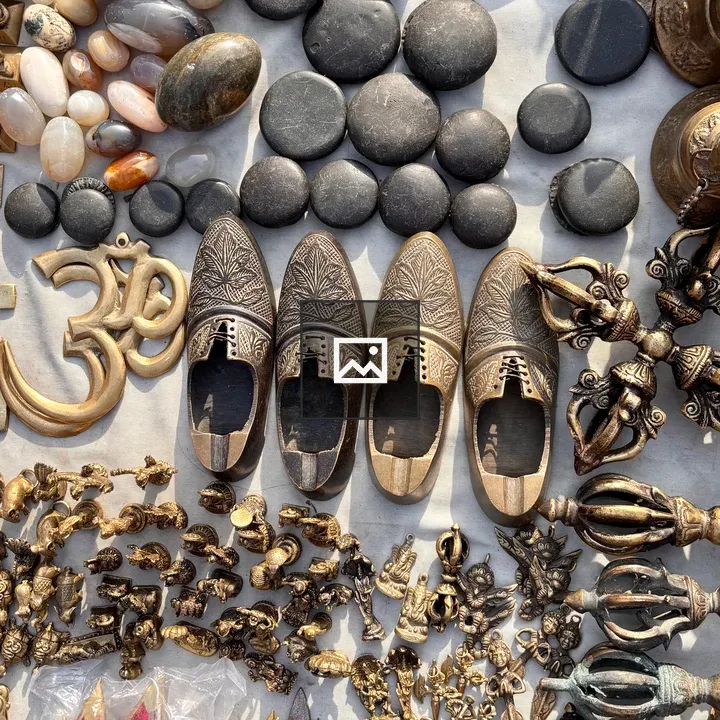 Display with carved metal shoes and Om symbol