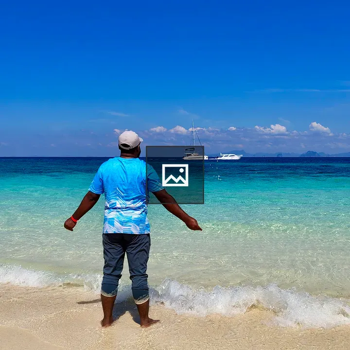 Man by the Ocean in a Blue Shirt
