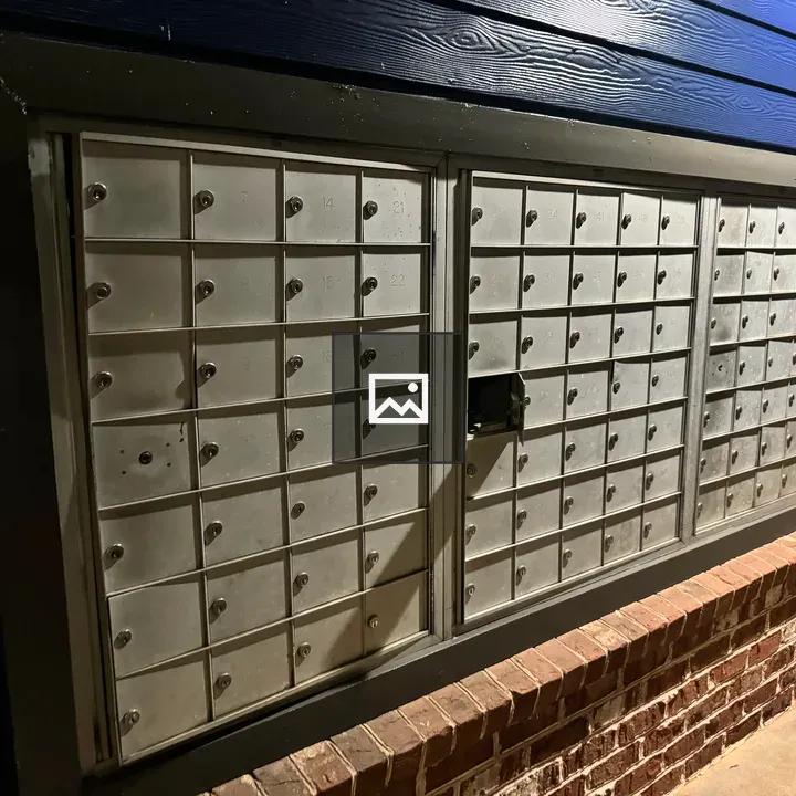 Metal lockable post boxes on wall