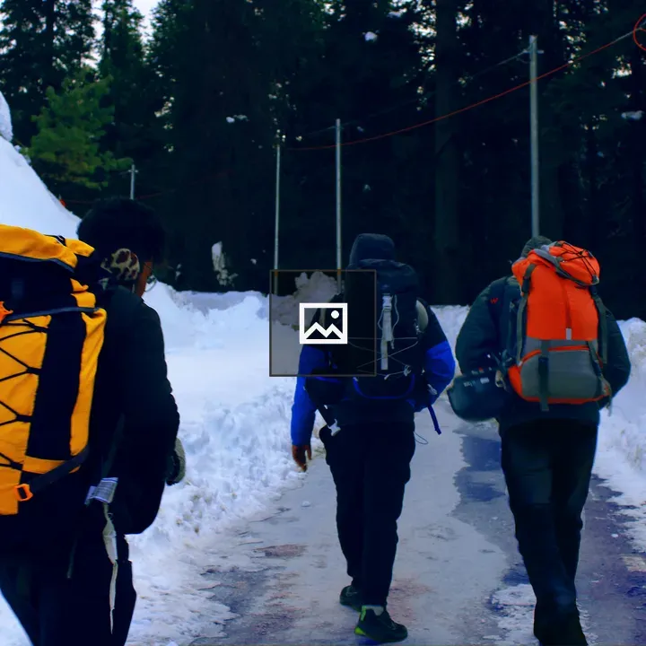 Backpackers on snowy path