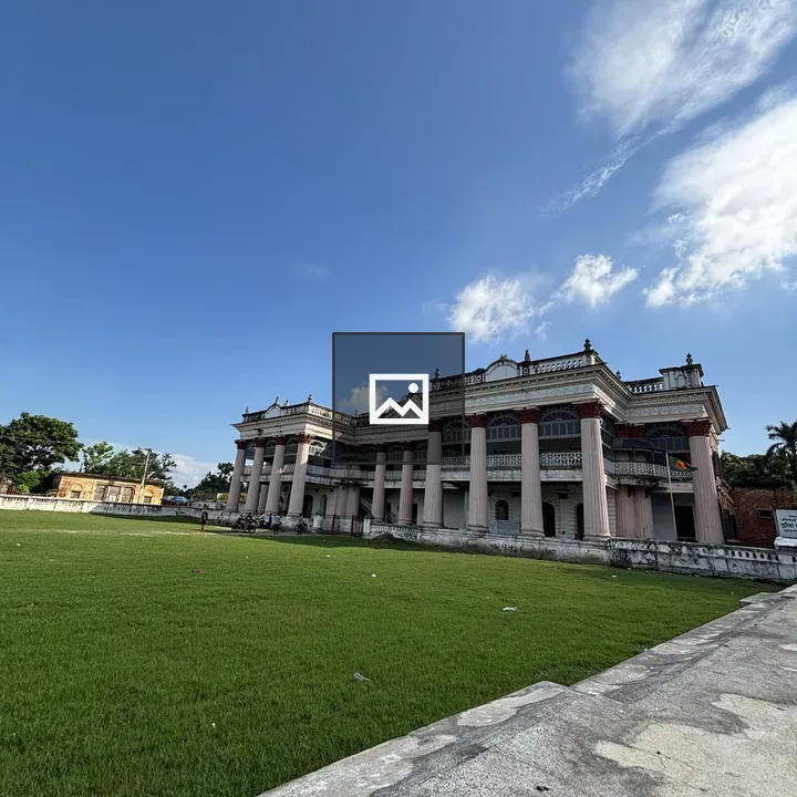 Building with grassy field and blue sky