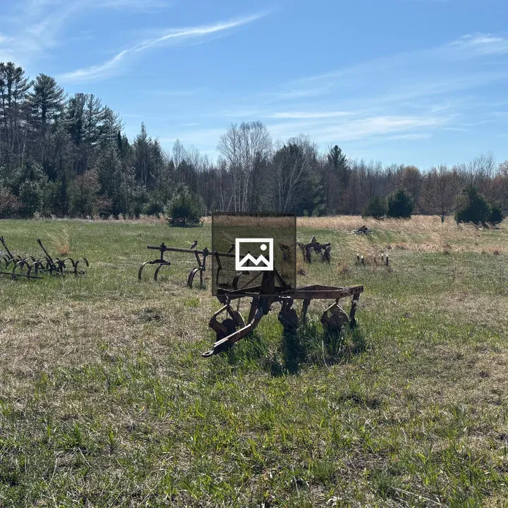 Open field with rusty farm equipment