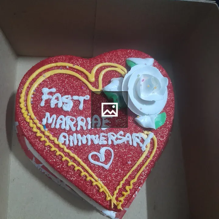 Heart-shaped cake in brown box