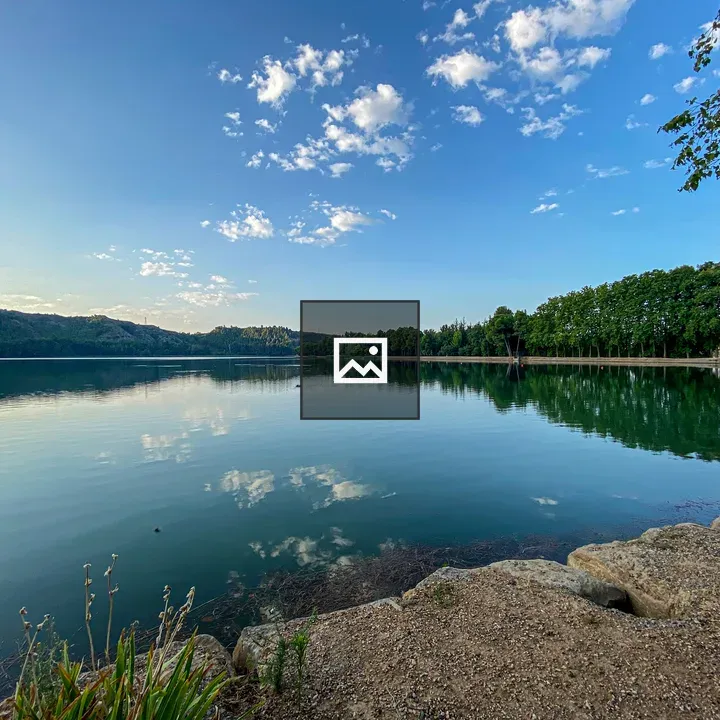 Serene lake with trees and sky