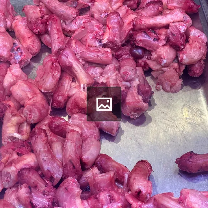 Raw meat pieces on metal tray
