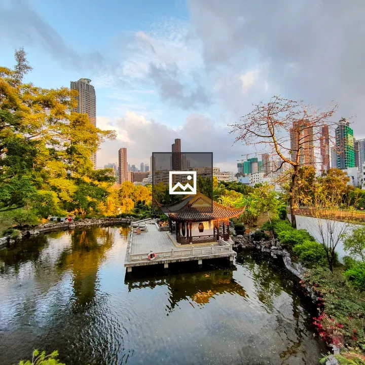 Pavilion by the pond with city backdrop