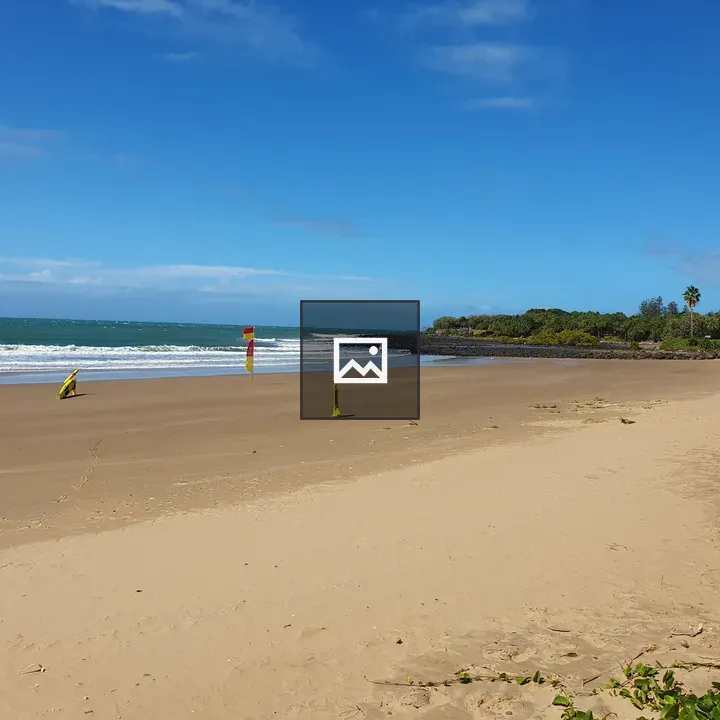 Beach scene with flags and sky