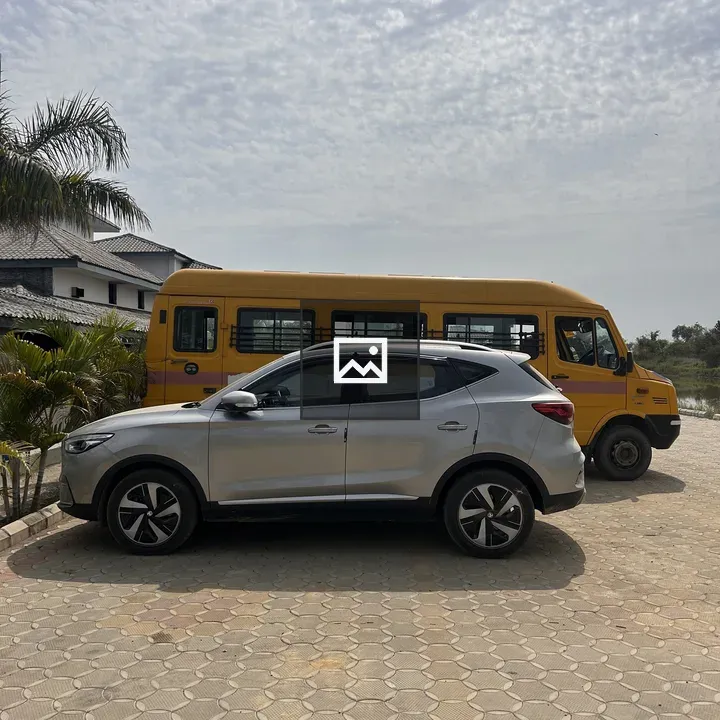 Silver SUV by Yellow School Bus