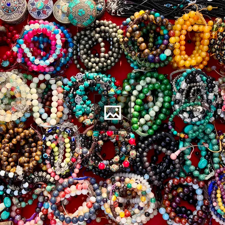 Beaded bracelets on red surface