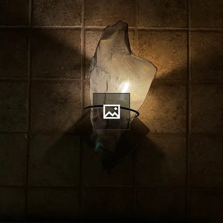 Lighting sconce on tile wall