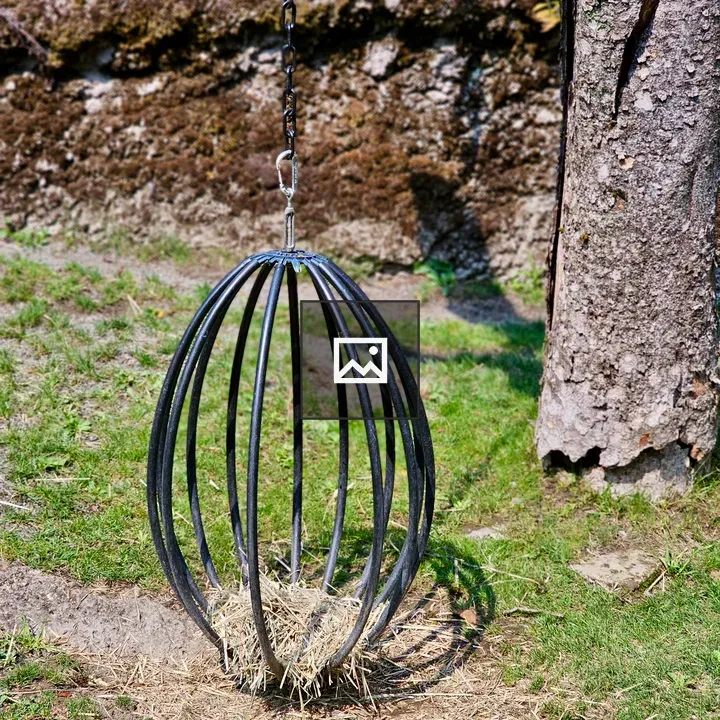 Metal feeder with straw outdoors